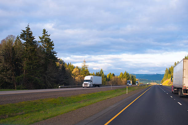 istock Interstate highway divided traffic lines semi trucks driving both directions 473982384