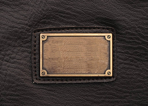 istock metal label on old black leather background 473982781