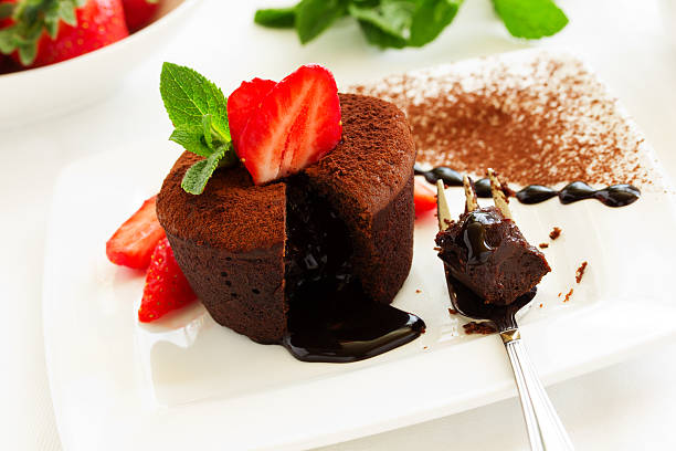 istock chocolate pudding with fudge center with strawberries, 473985358