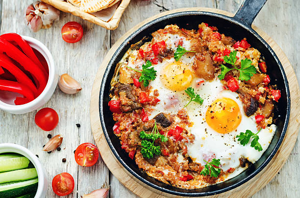 istock fried eggs with peppers, tomatoes, quinoa and mushrooms 473986838