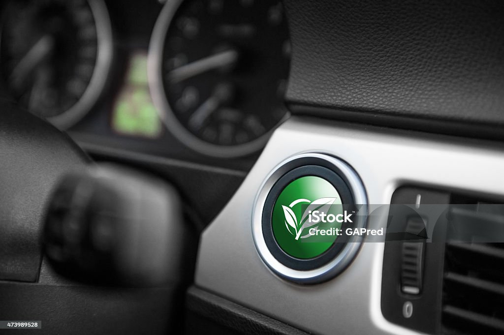 ECO mode button. Green ECO mode button on a dashboard of a sportive car. Car Stock Photo