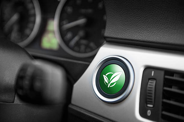 ECO mode button. Green ECO mode button on a dashboard of a sportive car. hybrid vehicle stock pictures, royalty-free photos & images