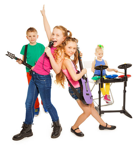 istock Girl singing and children playing as rock group 473991718