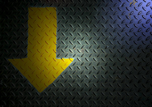istock Arrow on steel floor with light. 473994692