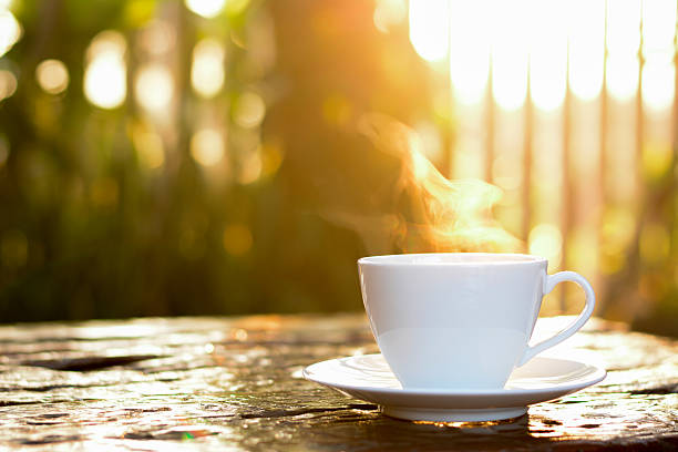 istock Hot coffee in the cup with morning sunlight 473995084