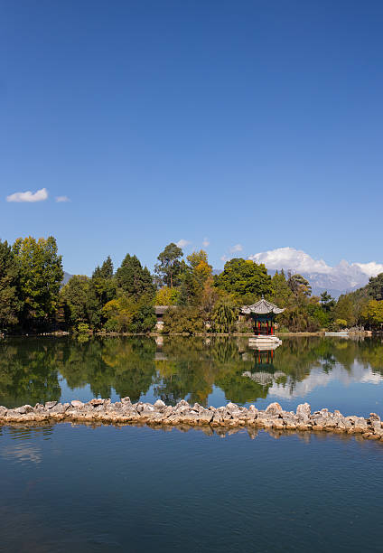 istock Chinese gazebo in the city pond 473997976