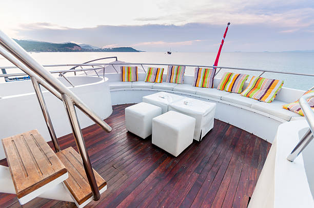 istock White stools and long seat on the yacht deck 474001420