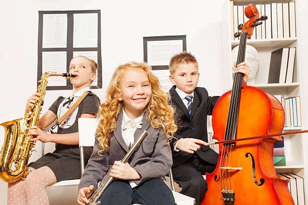 istock Happy children play musical instruments together 474002372