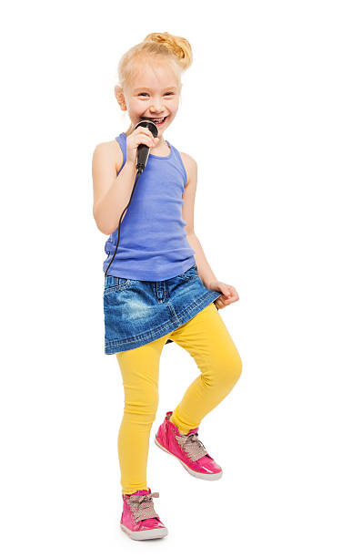 istock Happy girl singing in microphone and dancing 474003342