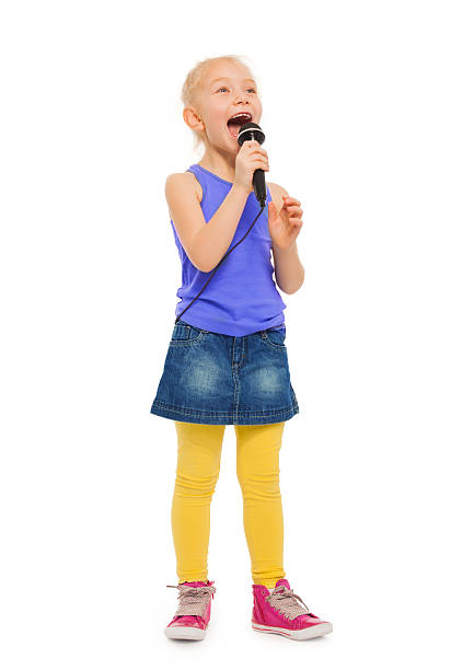 istock Girl singing karaoke in microphone and standing 474003348