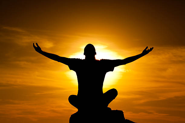 istock Silhouette of man with arms raised up and beautiful sky 474008334
