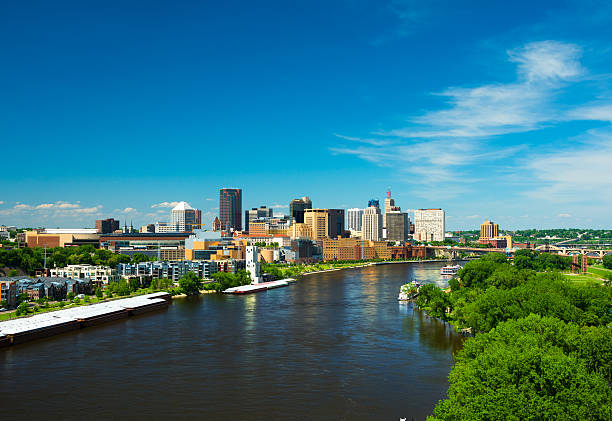 Saint Paul skyline with a river and trees, wide angle Saint Paul downtown skyline with the Mississippi River and trees in the foreground, wide angle view. image created 21st century blue architecture wide angle lens stock pictures, royalty-free photos & images