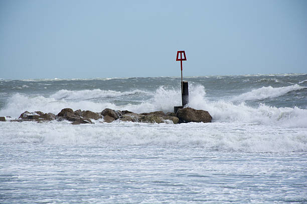 istock Waves splash into groyne at a beach in the UK 474011972