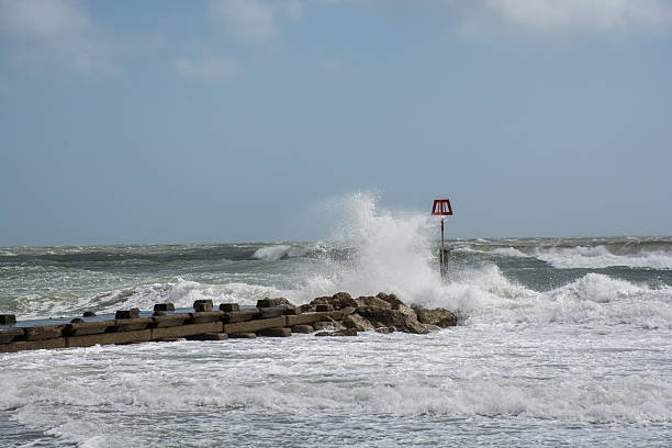 istock Waves bashing groyne on UK beach after storm 474011986