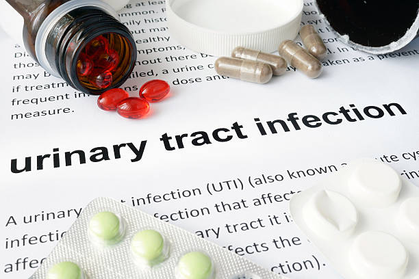 Paper with urinary tract infection  and pills. stock photo