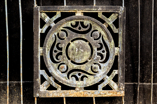 Dark cast Iron metal decoration from the soviet era of residential and social planning