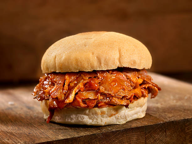 BBQ Beef Brisket Sandwich BBQ Beef Brisket Sandwich, Slow Cooked Beef Brisket thinly Sliced and Smothered in BBQ Sauce - Photographed on Hasselblad H3D2-39mb Camera barbecue beef stock pictures, royalty-free photos & images
