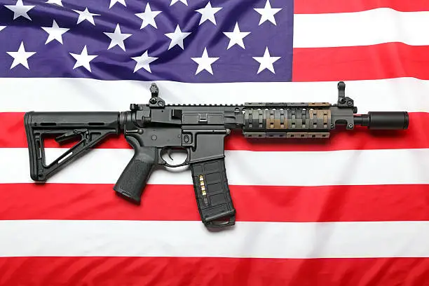 The "Black Rifle" AR-15 carbine and the flag of USA