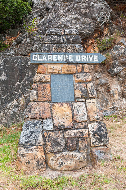 Weathered memorial stone Cape Town, South Africa - December 23, 2014: Weathered memorial stone remembering the person after which Clarence Drive between Gordons Bay and Rooi Els was named gordons bay stock pictures, royalty-free photos & images