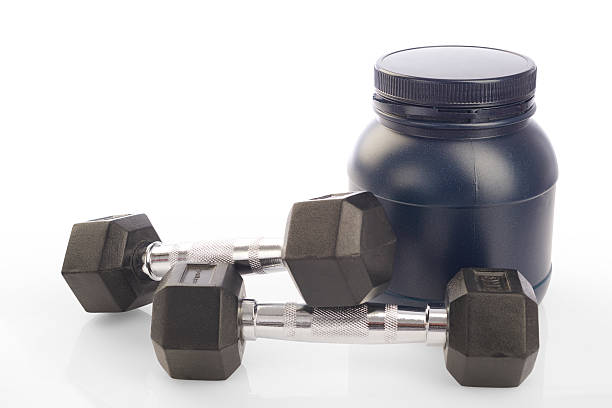 istock Isolated two dumbbells and protein powder bottle on white background 474036524