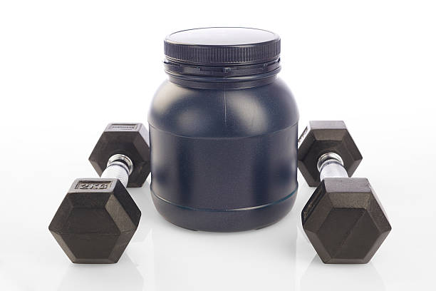 istock Isolated two dumbbells and protein powder bottle on white background 474036728