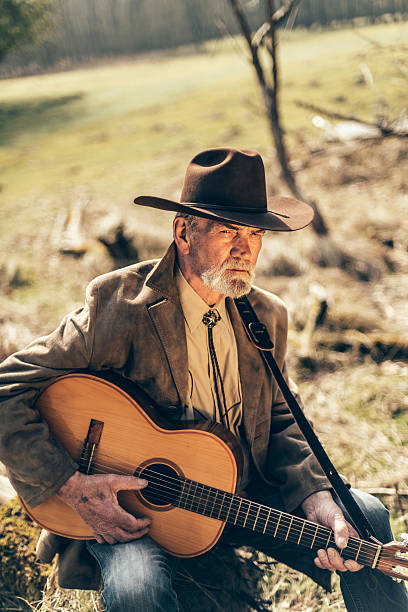istock Senior guitarist relaxing with his guitar 474036966