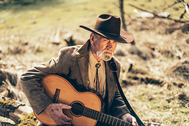 istock Lonely senior man sitting strumming his guitar 474036974