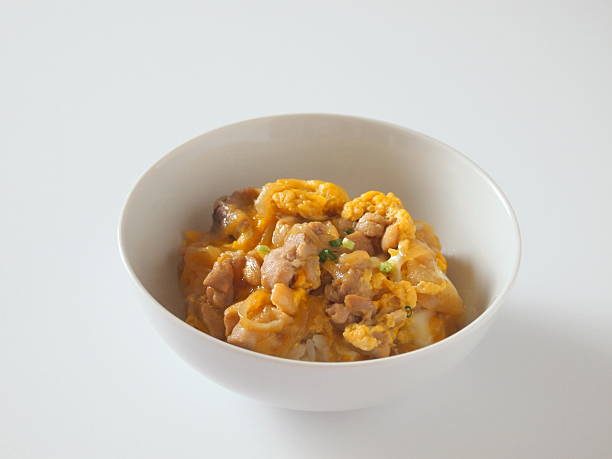 Oyakodon is a bowl of rice with (soy‐and‐sugar‐seasoned) chicken, egg, and vegetables.