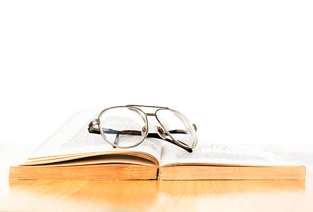 istock Vintage eye glass on opened old book 474037080