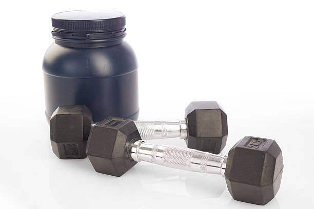 istock Isolated two dumbbells and protein powder bottle on white background 474037204