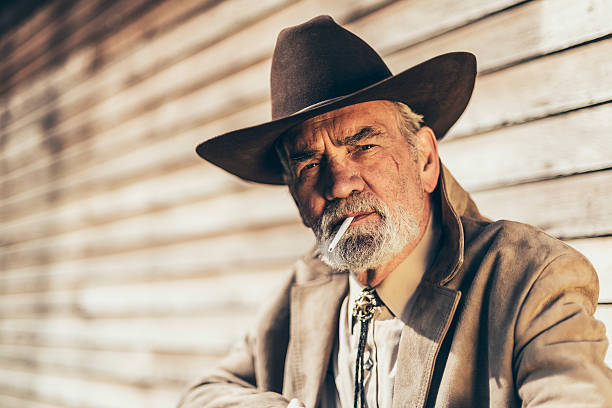 istock Senior man smoking a cigarette with a pensive look 474037594