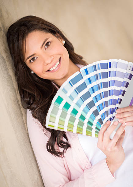 istock Woman painting her house 474037670