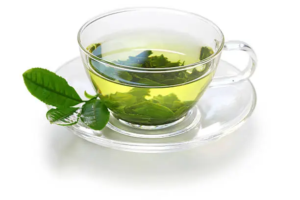 glass cup of Japanese green tea and teapot isolated on white background