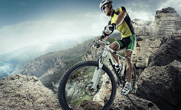 istock Bicyclist about to ride down a rugged extreme mountain 474039044