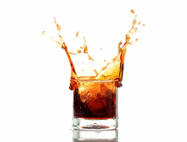 istock splash of cola in glass isolated on white background 474039540
