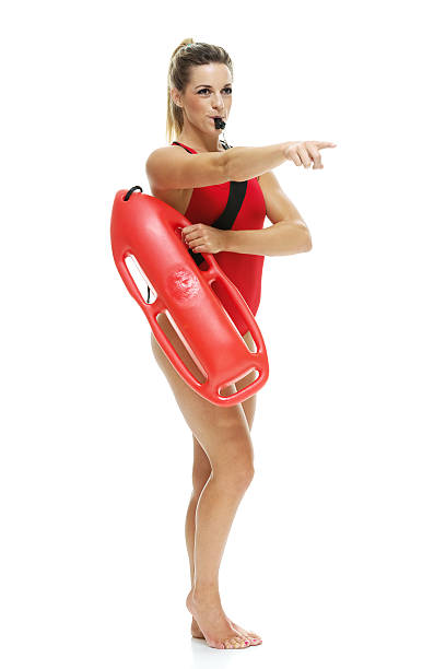 istock Female lifeguard with life buoy and whistle 474046366