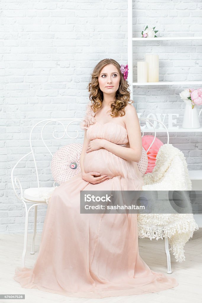 Pregnant woman portrait Beautiful pregnant woman, full lenght portrait. Elegant evening dress, professional hairstyle and make-up 2015 Stock Photo