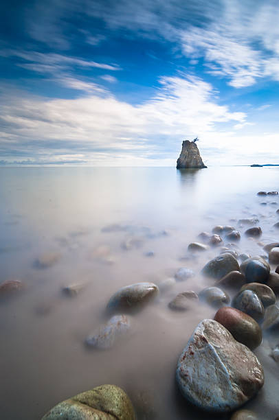 Morning at the beach This photo taken using long exposure technic to make the water like sap. penyu kuala stock pictures, royalty-free photos & images