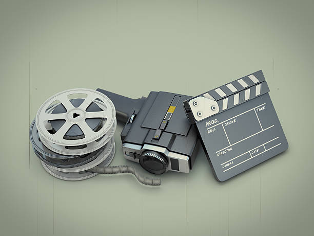 istock Ancient movie camera near a clapperboard and a film 474055018