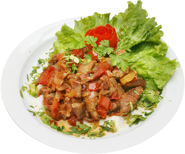Crispy, thinly sliced sun-dried beef (dendeng) smothered in a bold lado merah sauce made from fiery red chilies, shallots, and garlic. This iconic Padang dish balances smoky, savory meat with a vibrant chili glaze, garnished with fried shallots and fresh lime leaves. isolated on white plate