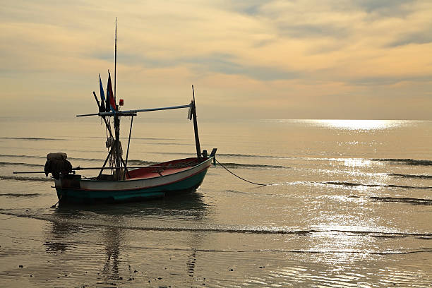 istock fishing boat on sea at sunrise 474056032