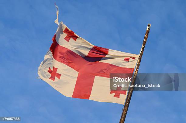 Old Georgian National Flag With Red Crosses And Blue Sky Stock Photo - Download Image Now