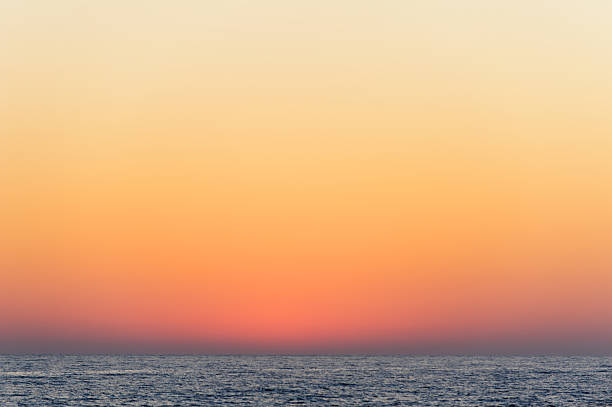 Clear sunset sky over sea stock photo