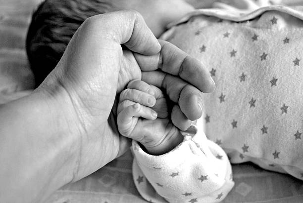 istock Newborn baby girl's hand 474063372