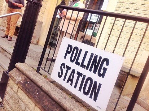 A photograph to illustrate a working Polling Station in Hove, May 2015, with a Green Party teller outside.