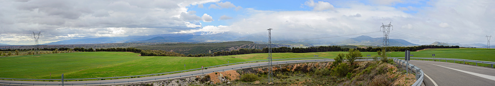 Panoramic view with road, mountains and cloudscape in Spain