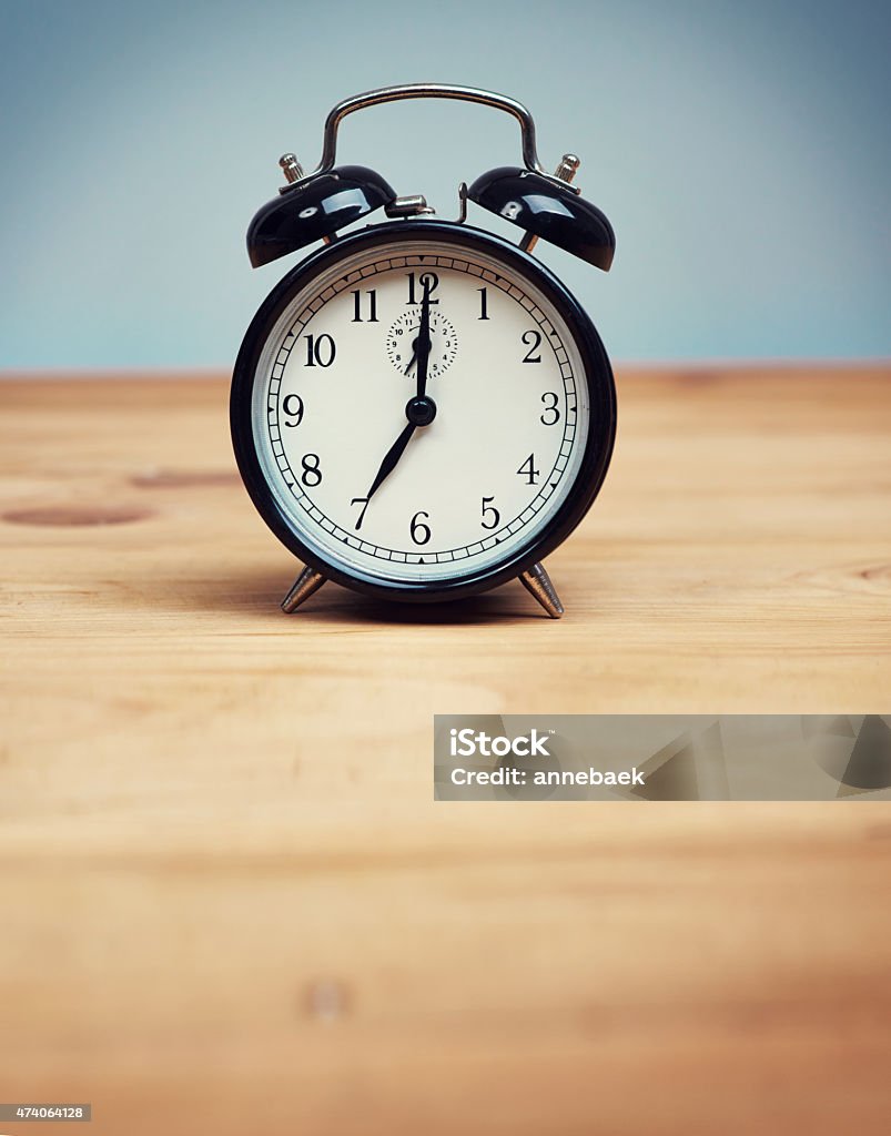 Time to wake up! Shot of an alarm clock on a wooden tablehttp://195.154.178.81/DATA/i_collage/pu/shoots/804615.jpg 2015 Stock Photo