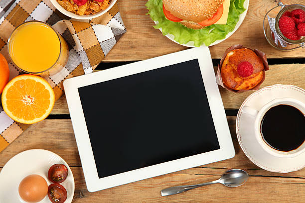 tablet and food stock photo