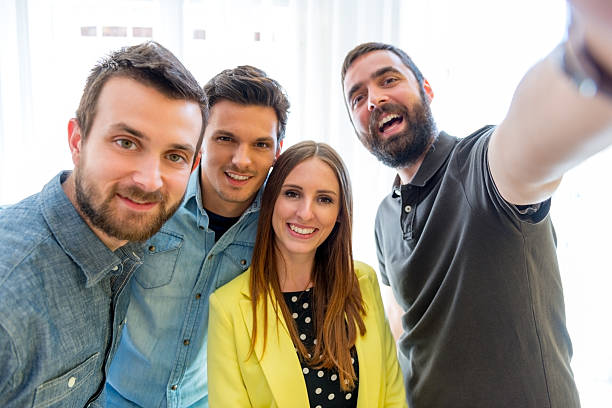 Team of four taking a selfie together