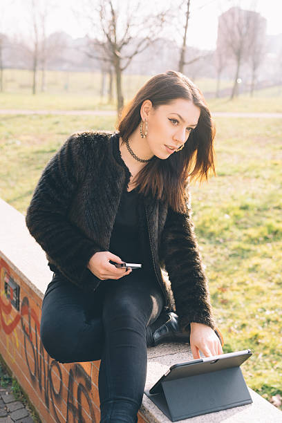 istock young beautiful woman using tablet and smartphone 474069352